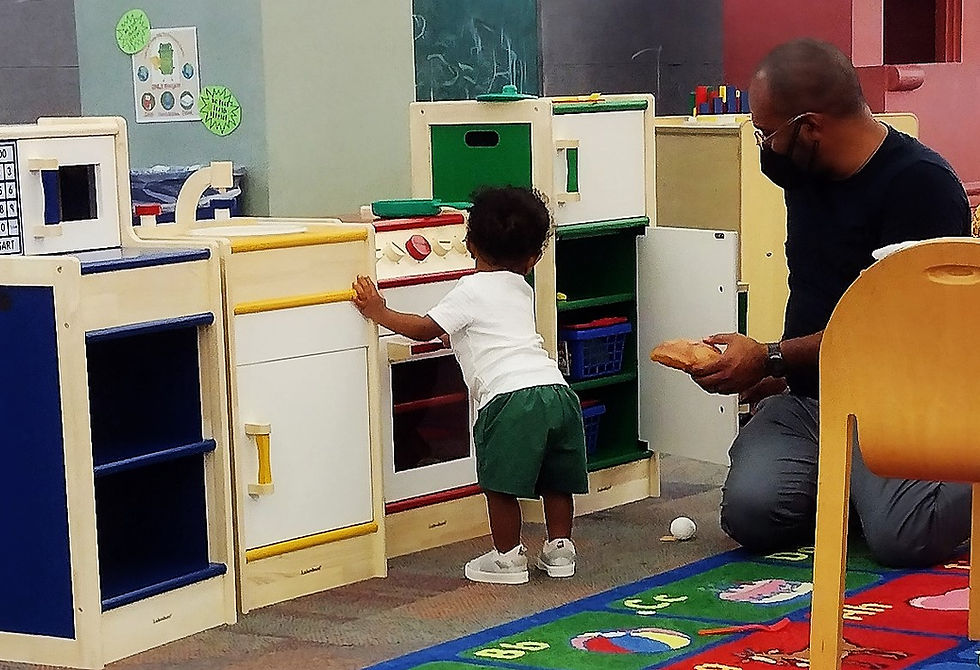 Man and boy playing in the Reading Ready Play area