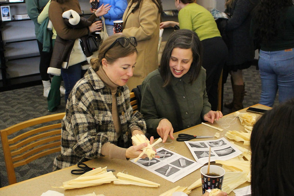 Two women women working on a craft project at the library